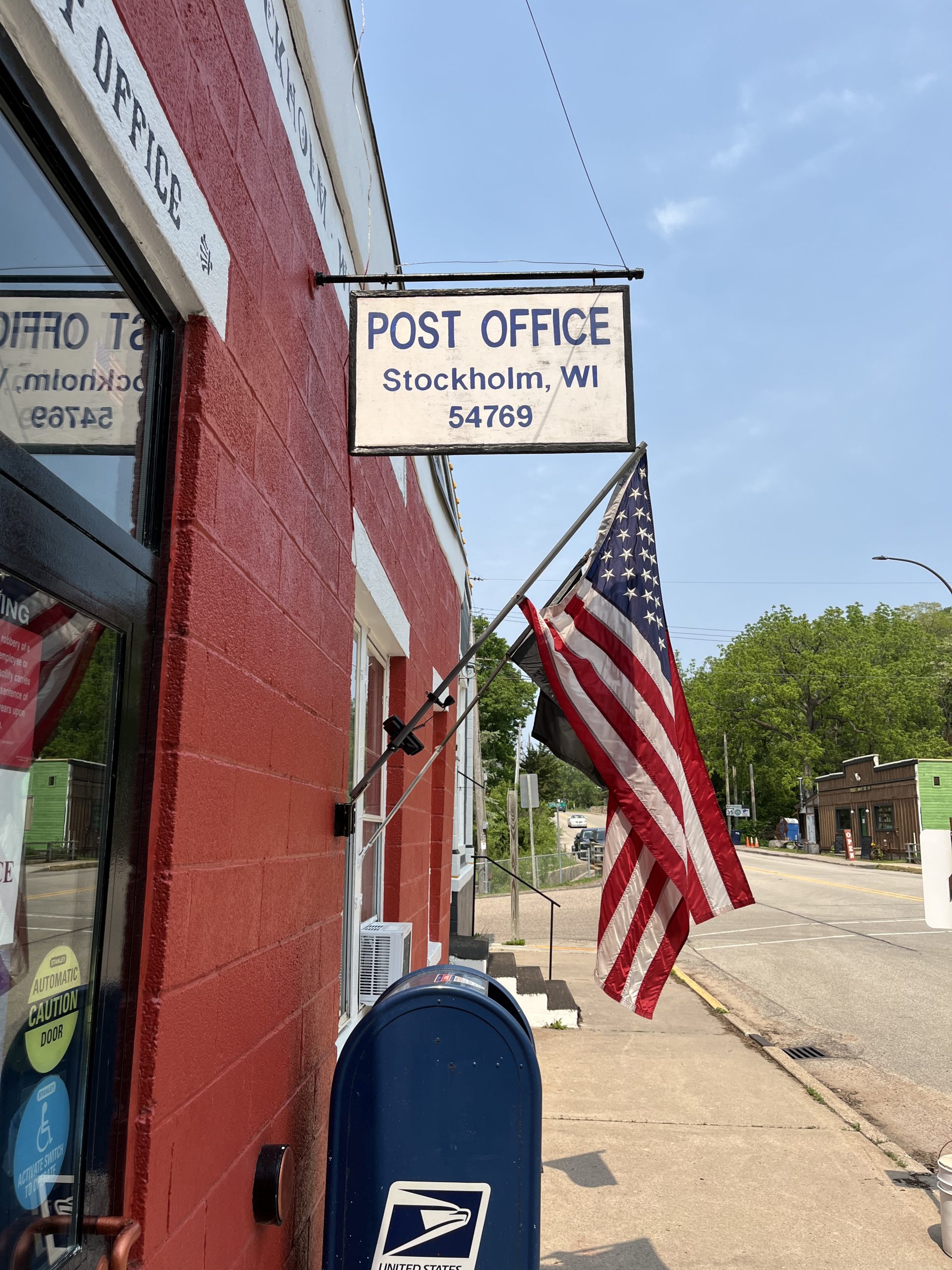 Stockholm, WI Post Office Main Street post office with US flag and USPS mailbox